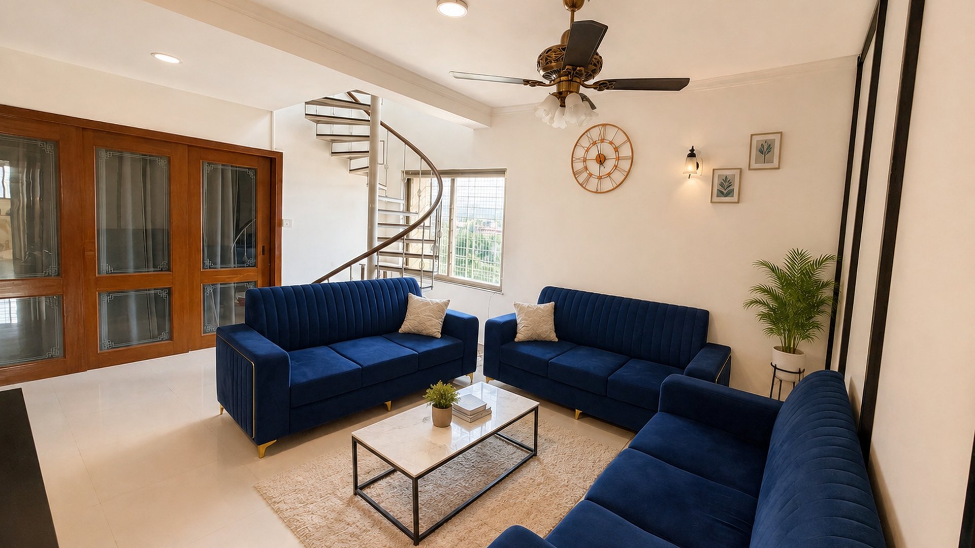 Bright, furnished shared living room with blue sofas at Go GenZ Stays